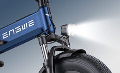 Close-up of a blue Engwe Engine Pro 3.0 Boost Folding Electric Bike and a headlight on a gray background.