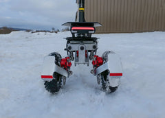 Robot with wheels and red components on a snowy ground