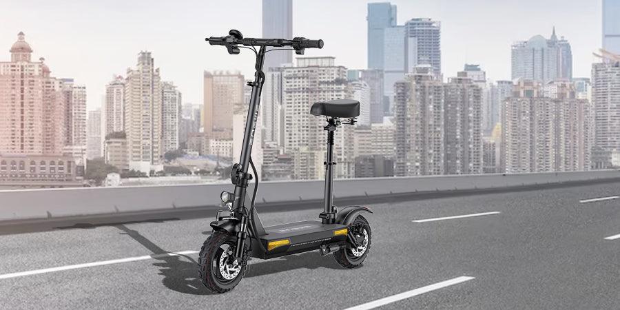 Black electric scooter with seat, side view, on city road with skyscrapers in background